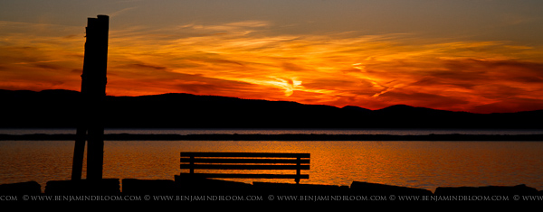 An early March sun sets behind the Adirondack mountains and Lake Champlain.